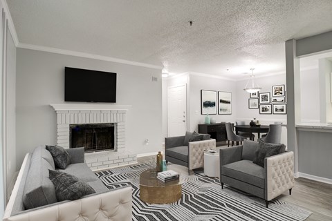 a living room with couches and chairs and a fireplace